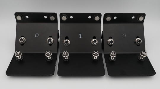 Three black metal bracket hardware pieces with silver bolts and washers, arranged side by side on a light gray background.