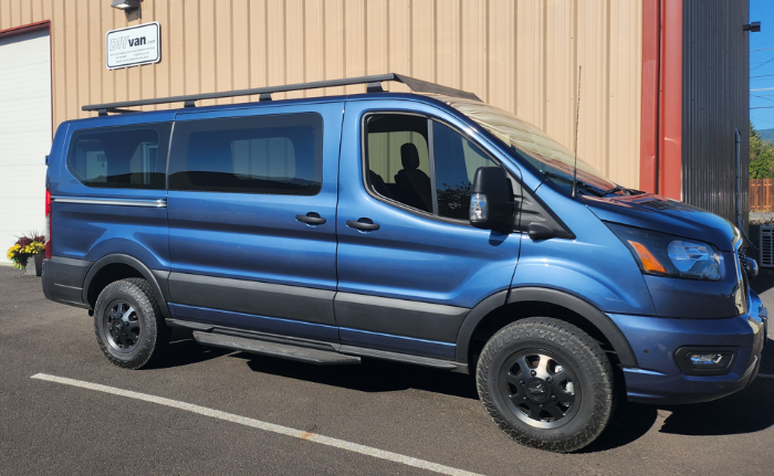 Blue Transit van with DIYvan rails and spoiler
